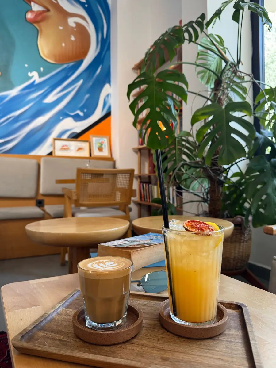 Latte og friskpresset juice på træbord